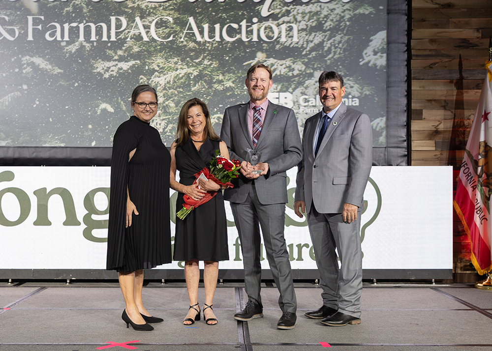 Janet Kister, second from left, receives the Distinguished Service Award from Shannon Douglass, left, Shaun Crook and Ron Peterson.