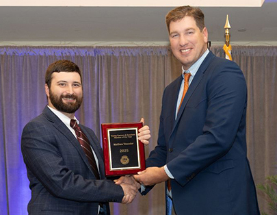 Matthew Vosseler, left, receives the California Farm Bureau’s Young Farmers & Ranchers Star Member Award from Daniel Jones, YF&R State Committee chair.