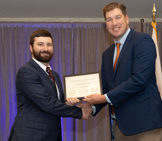 The Sonoma-Marin Young Farmers & Ranchers Committee, represented by Matthew Vosseler, left, receives the YF&R award for its support of FarmPAC from Daniel Jones, YF&R State Committee chair.