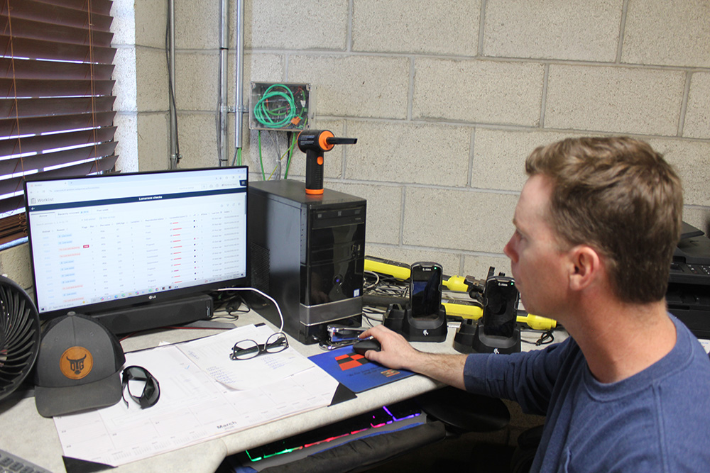 Tyler Ribiero, a partner at Rib-Arrow Dairy in Tulare, studies the latest locomotion data provided by vision technology. 