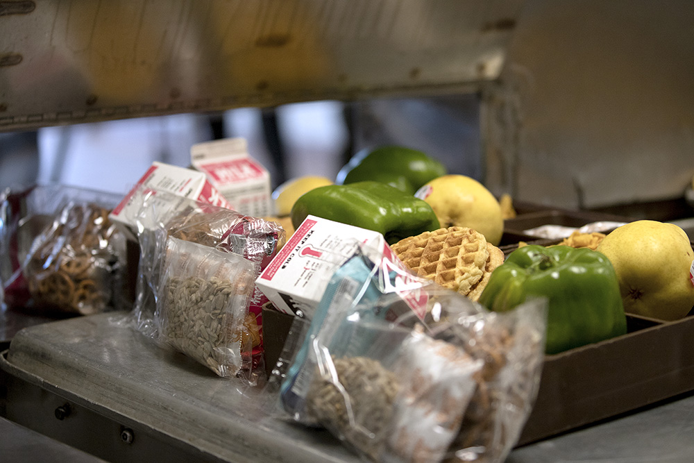 California-grown pears and bell peppers supplied by the Harvest of the Month program are shown on meal trays at California State Prison, Solano in 2023.